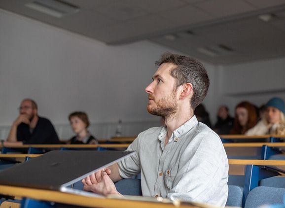A student sitting listening in a lecture