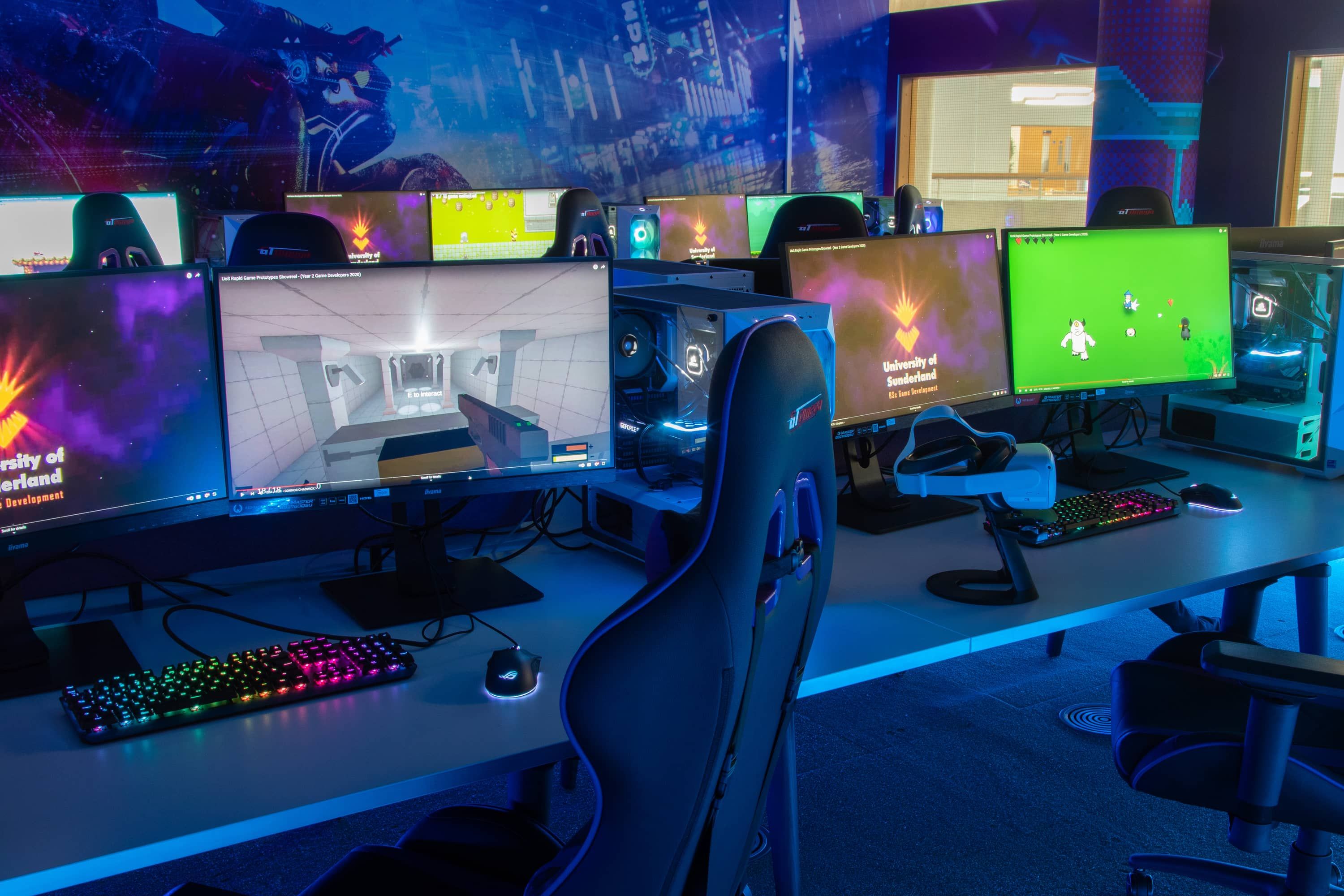 The Game Development Lab, with GT Omega PRO Series gaming chairs, dual-screen setup with 27-inch widescreen monitors, mechanical keyboards and RGB mice