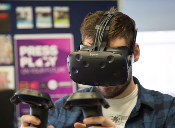 Student wearing VR headset holding controllers