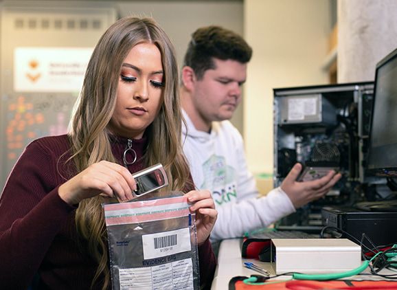 Two students looking at computing equipment