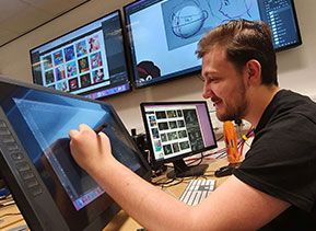 An animation student working on a design on a Wacom Cintiq screen