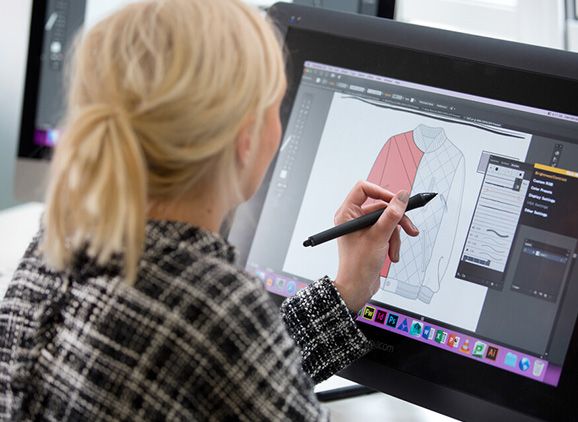 A fashion student sketching a product on a screen