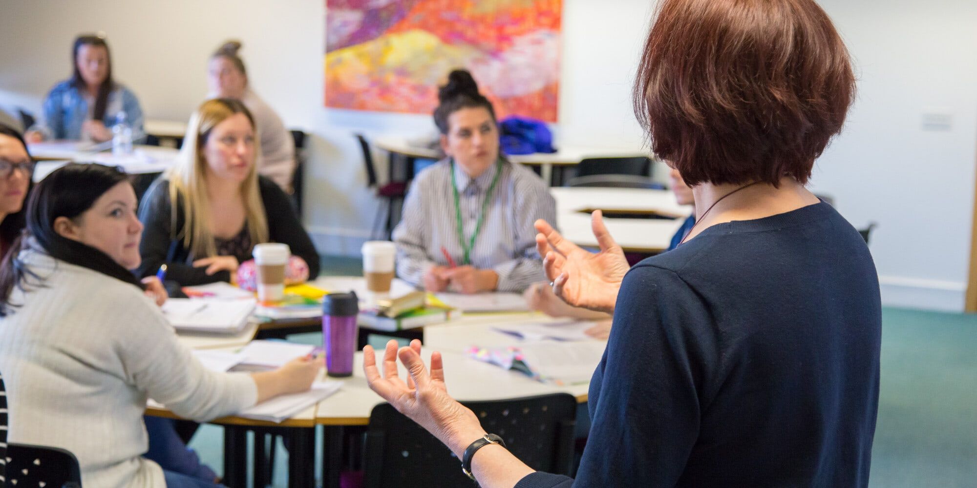 An academic teaching a group of students