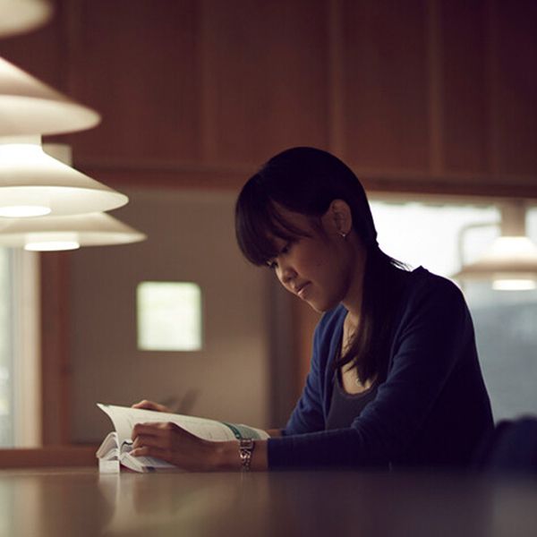 A student sitting at a desk reading a book