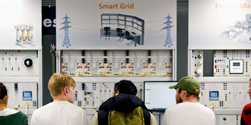 A group of students looking at engineering equipment