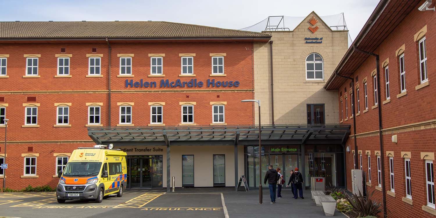 An exterior shot of Helen McArdle House with the mock ambulance parked up outside