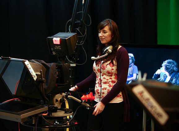 A student filming with a TV camera