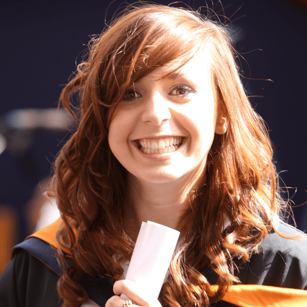 A student with graduation scroll