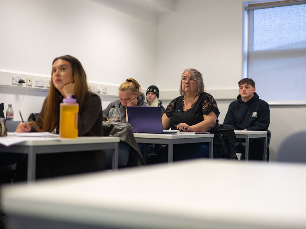 A classroom of students looking towards the front