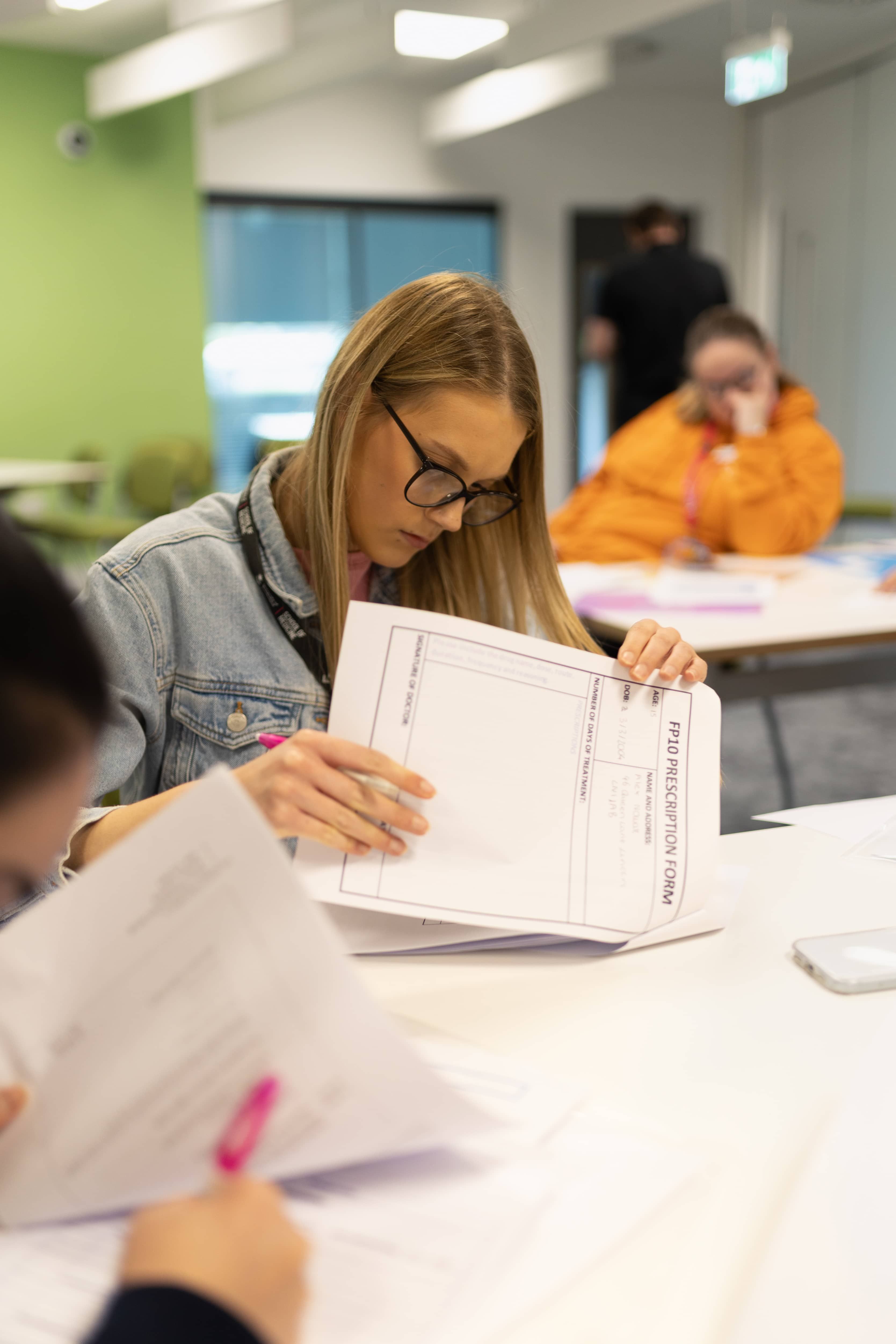 Medstart student sitting at a desk reading information during a session