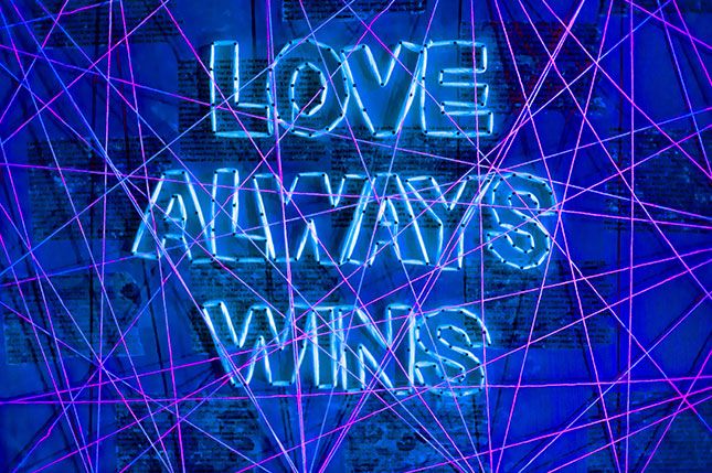 A neon and wool on wood sign that says Love Always Wins