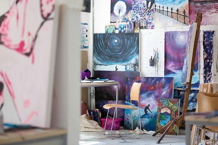 Purple and blue colour paintings hanging in a fine art studio 