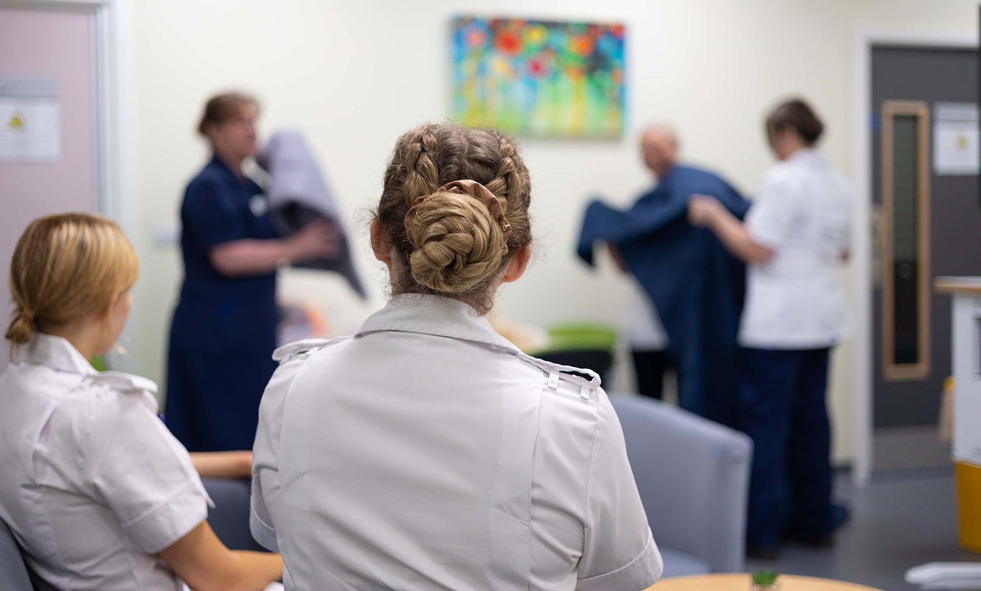 Nursing students watching a demonstration in the mock mental health ward