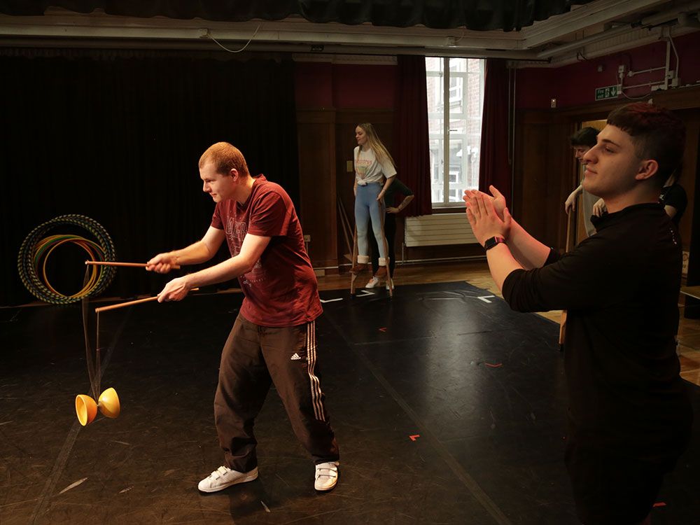 A group of performance students taking part in a circus masterclass