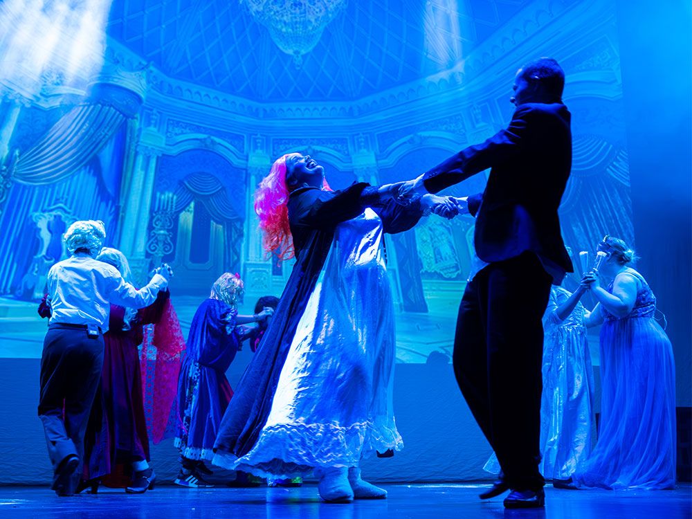 A group of students performing a dance number during a dress rehearsal of their final showcase
