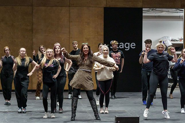 A group of students rehearsing a performance of Sister Act in the Fire Station Auditorium