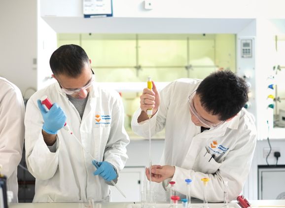 Two students working in lab