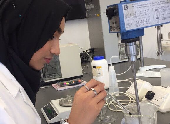 A cosmetic science student working in the lab