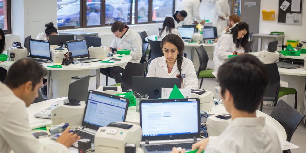 A group of Pharmacy students working in the simulated pharmacy