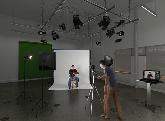 A photographer photographing someone in the studio