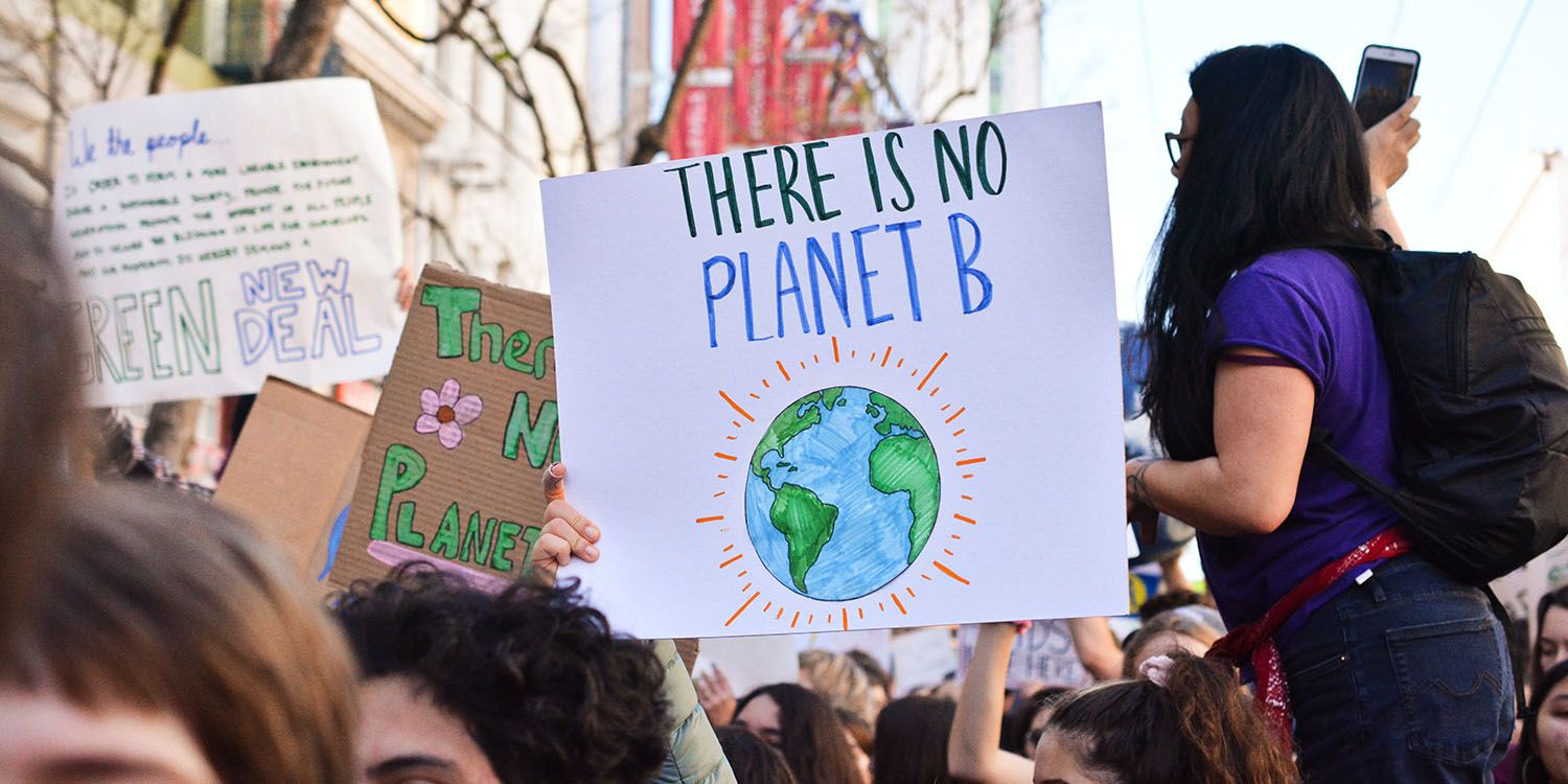 A crowd protesting climate change with placards