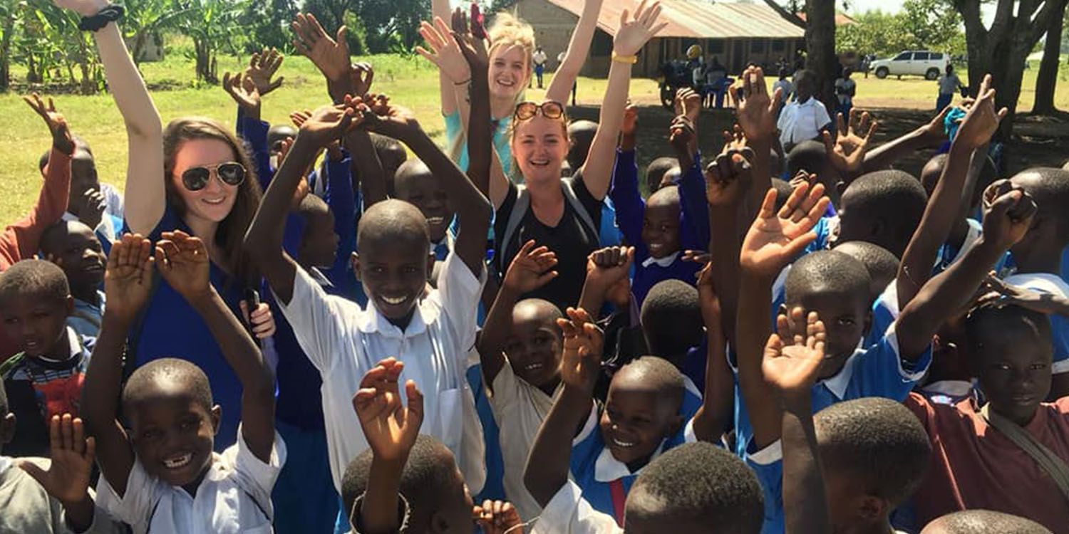 Students with children on a volunteering experience in Kenya