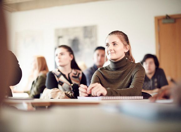 Students sitting listening in a classroom