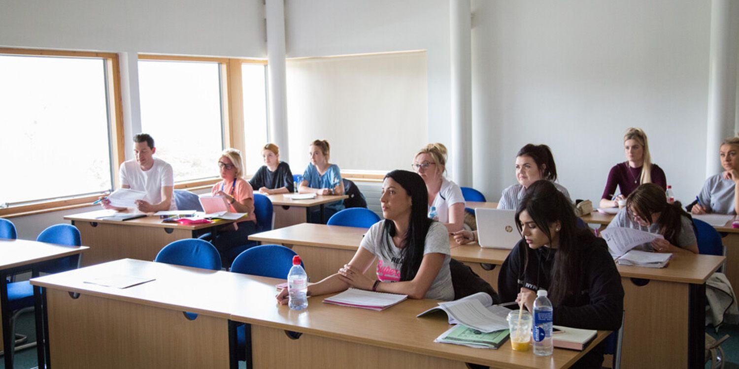 Students sitting in rows in a classroom during a lesson